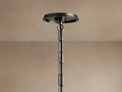 Close-up of Wescott Cone Pendant: dark bronze-finish metal fixture with vertical grooves meeting a milky white glass cone.