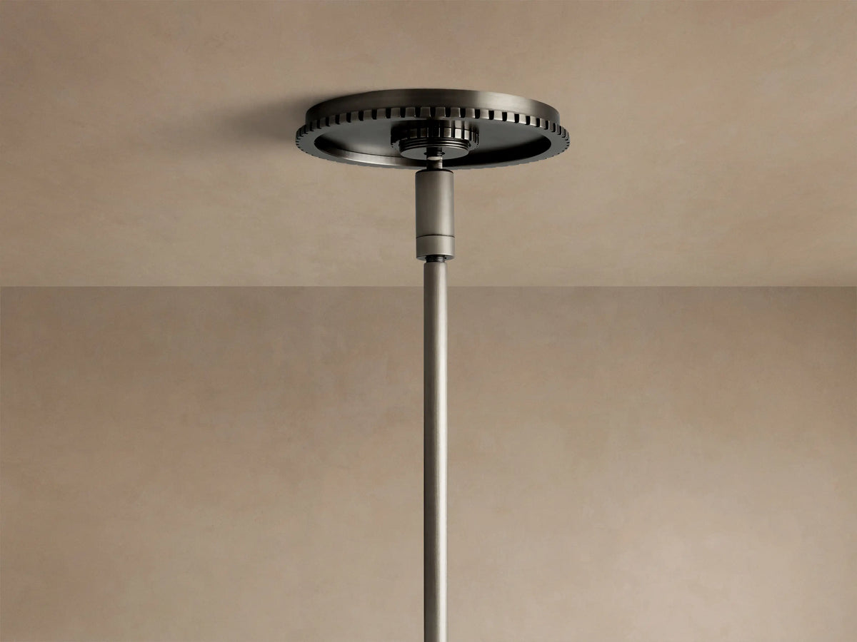 Close-up of Wescott Cone Pendant: milky white glass shade, dark bronze-finish metal ring with vertical details, and a curved rod.