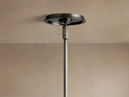 Close-up of Wescott Cone Pendant: milky white glass shade, dark bronze-finish metal ring with vertical details, and a curved rod.