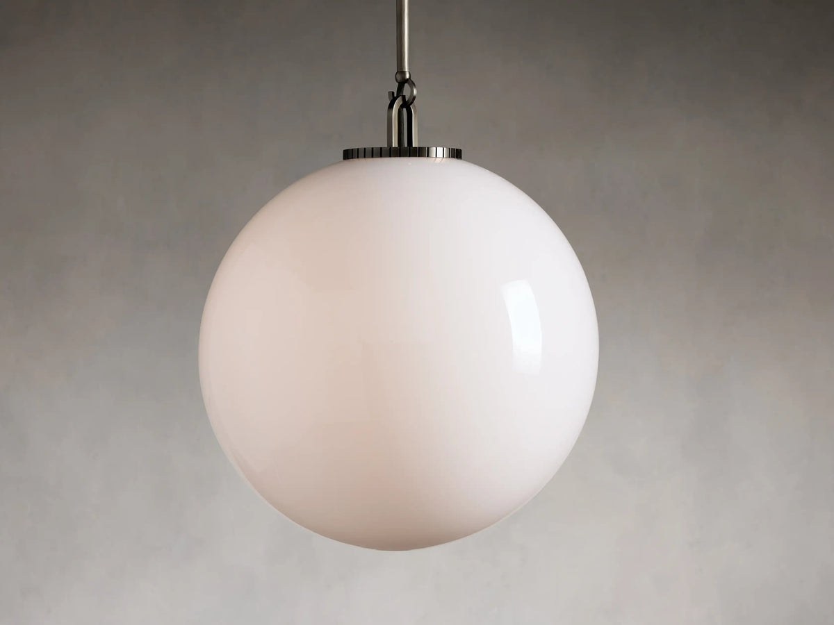 Clear glass globe pendant light with black metal rod, showing interior bulb. Globe is large and spherical, hanging vertically.