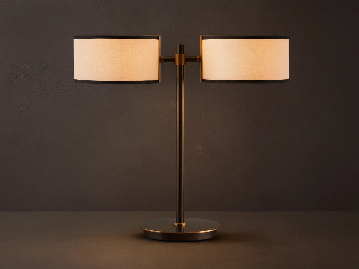 Daphne 2-Light Table Lamp with black-finished base and two white linen shades with black trim on a wooden surface.