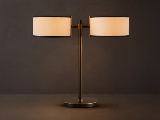Daphne 2-Light Table Lamp with black-finished base and two white linen shades with black trim on a wooden surface.
