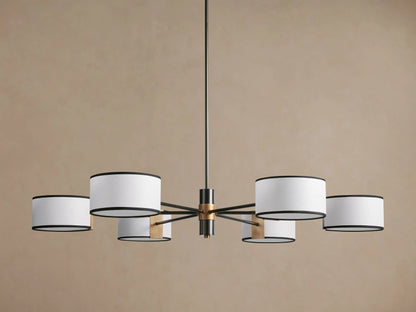 Daphne Fabric Round Chandelier with 6 white linen shades and black trim, dark bronze arms, hanging against a brown wall.