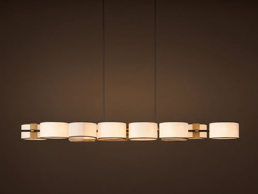 Daphne Fabric Linear Chandelier with 6 white fabric shades, black trim, and gold accents, hanging from two dark rods.