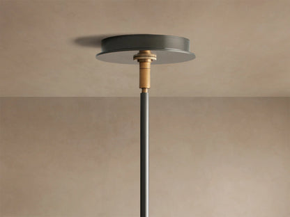 Close-up of Daphne Chandelier's white linen shade with black trim, attached to a black arm with a bronze accent.