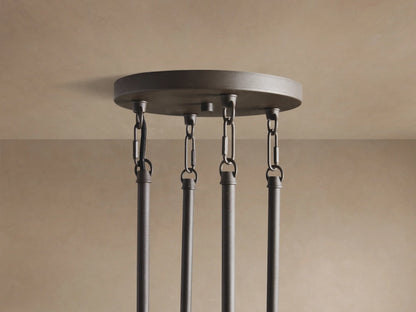 Andreas Round Chandelier close-up: dark gray frame, clear ribbed glass cylinders, visible warm filament bulbs.