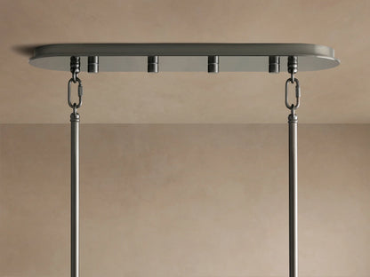Delsie Oval Chandelier's bronze oval canopy mounted to a beige ceiling, with two chains and rods hanging down.