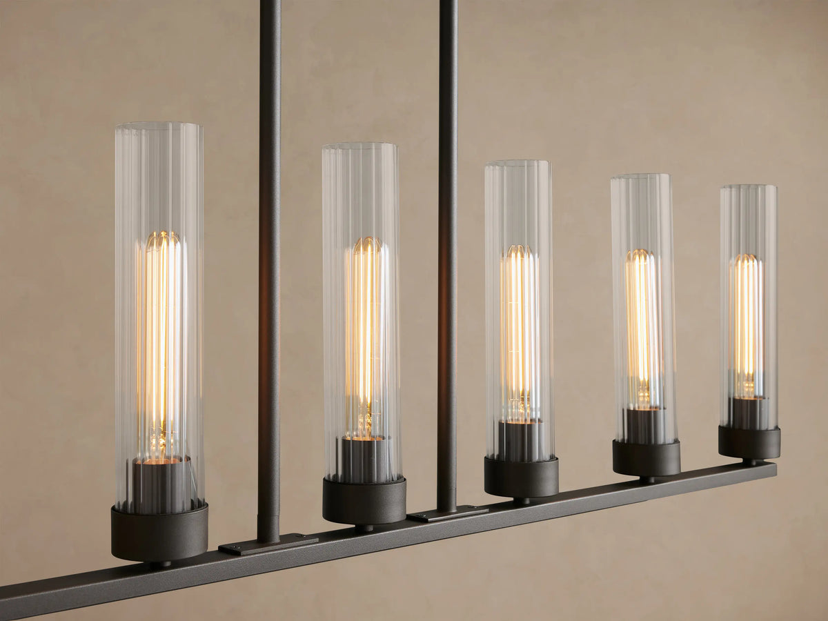 Andreas Linear Chandelier, dark bronze, 8 warm filament bulbs in clear ribbed glass, suspended by black chains.