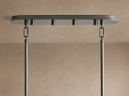 Delsie Oval Chandelier's dark bronze-toned oval canopy mounted to a light ceiling, with two metal chains and rods hanging.