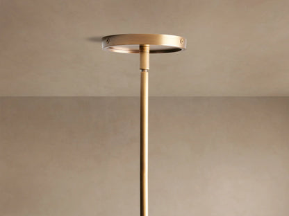 Close-up of Theron Linear Chandelier with a brass bar suspending three illuminated frosted glass cones, fourth partially visible.