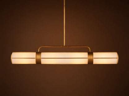 Remming Linear Chandelier: horizontal fixture with three glowing milk glass shades and burnished brass framework.