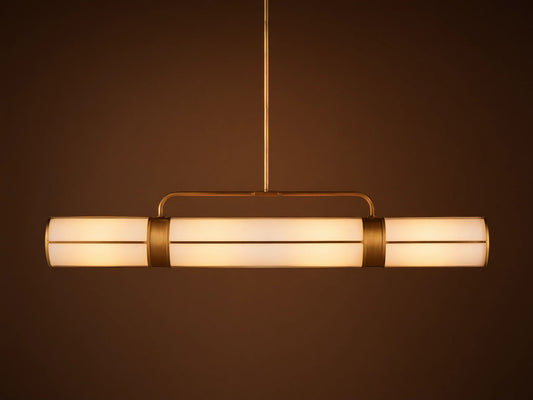 Remming Linear Chandelier: horizontal fixture with three glowing milk glass shades and burnished brass framework.