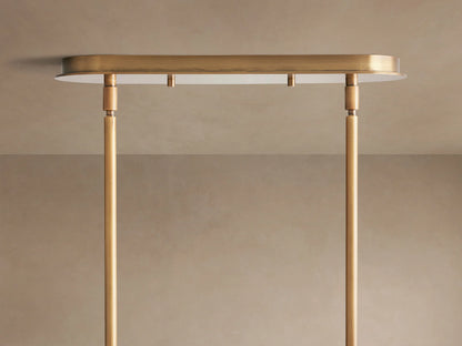 Close-up of Remming Linear Chandelier, featuring horizontal white milk glass cylinder held by burnished brass bands & pipe.