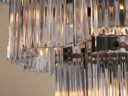 Delsie Round Chandelier, a large tiered fixture composed of many vertical clear glass rods, creating a cascading conical shape.