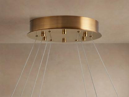 Front view of the white Halima Halo Chandelier, a large alabaster stone ring suspended by thin wires from above.