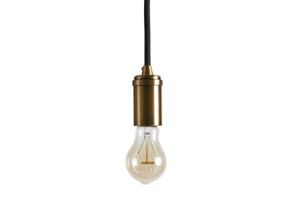 The Ohlson Brass Swag Pendant features a brass-plated socket with an exposed lightbulb, hanging by a black fabric-wrapped cord.