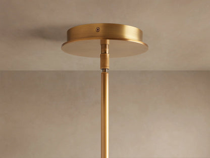 Lyla Single Pendant: Close-up of glowing white marbled hand-blown glass shade attached to a brushed brass fixture.