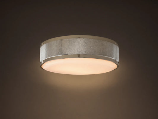 Round ceiling light with a brushed metal frame and frosted glass diffuser. Soft warm glow, mounted on a neutral-colored ceiling.