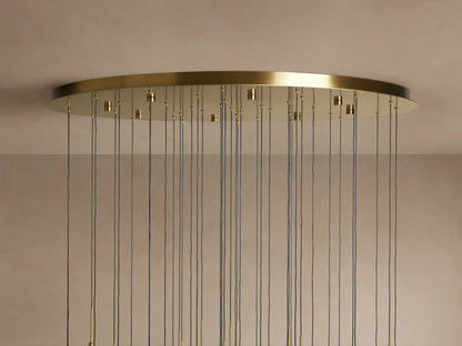 Solitaire Round Chandelier with brass finish, thin black cords hanging from a circular base mounted on the ceiling.