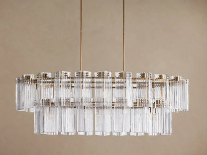 Delsie Oval Tiered Chandelier with burnished brass frame, two tiers of clear fluted glass rods, and visible bulbs.