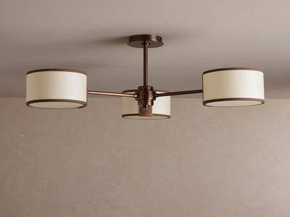 Daphne Fabric Flush Mount with three glowing creamy fabric shades & dark bronze accents, mounted on a ceiling.