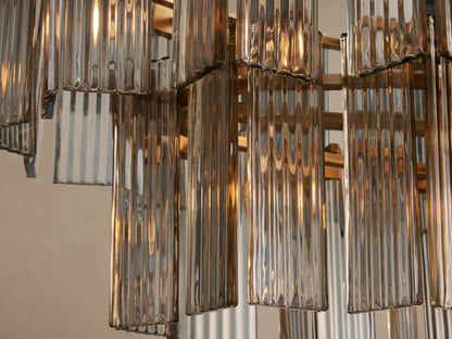 Delsie Oval Tiered Chandelier with two tiers of clear fluted glass panels and a burnished brass frame.