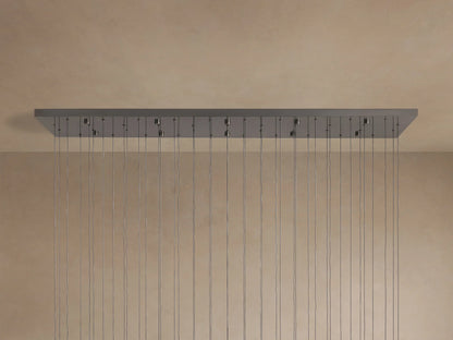 Soltaire Linear Chandelier: long rectangular metallic grey canopy with many evenly spaced thin wires hanging down from a ceiling.