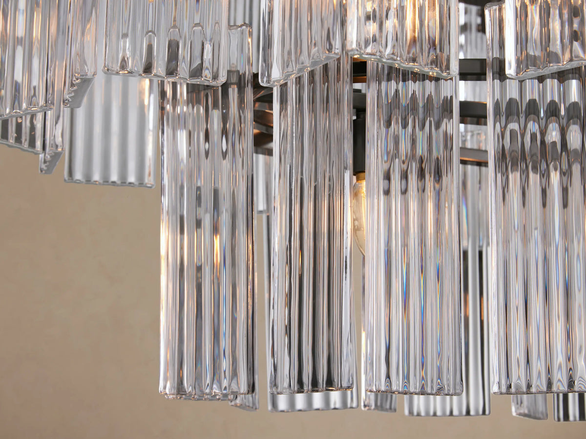 Delsie Oval Tiered Chandelier, two tiers of clear glass rods hanging from a dark metal frame, suspended by dark rods.