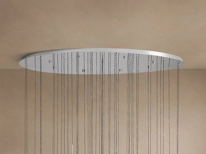 Soltaire Round Chandelier. Close-up of clear glass teardrop pendants with internal bubbles and polished nickel caps, illuminated from within.
