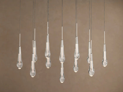 Soltaire Linear Chandelier with sparkling clear teardrop glass pendants, silver-finished tops, hanging at various lengths.