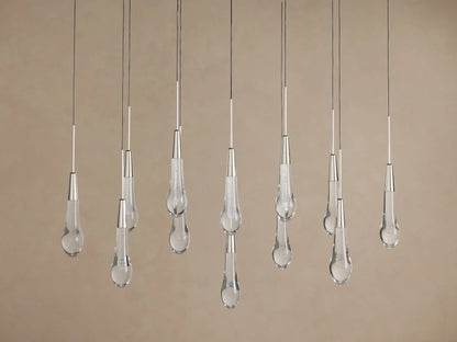 Soltaire Linear Chandelier with sparkling clear teardrop glass pendants, silver-finished tops, hanging at various lengths.