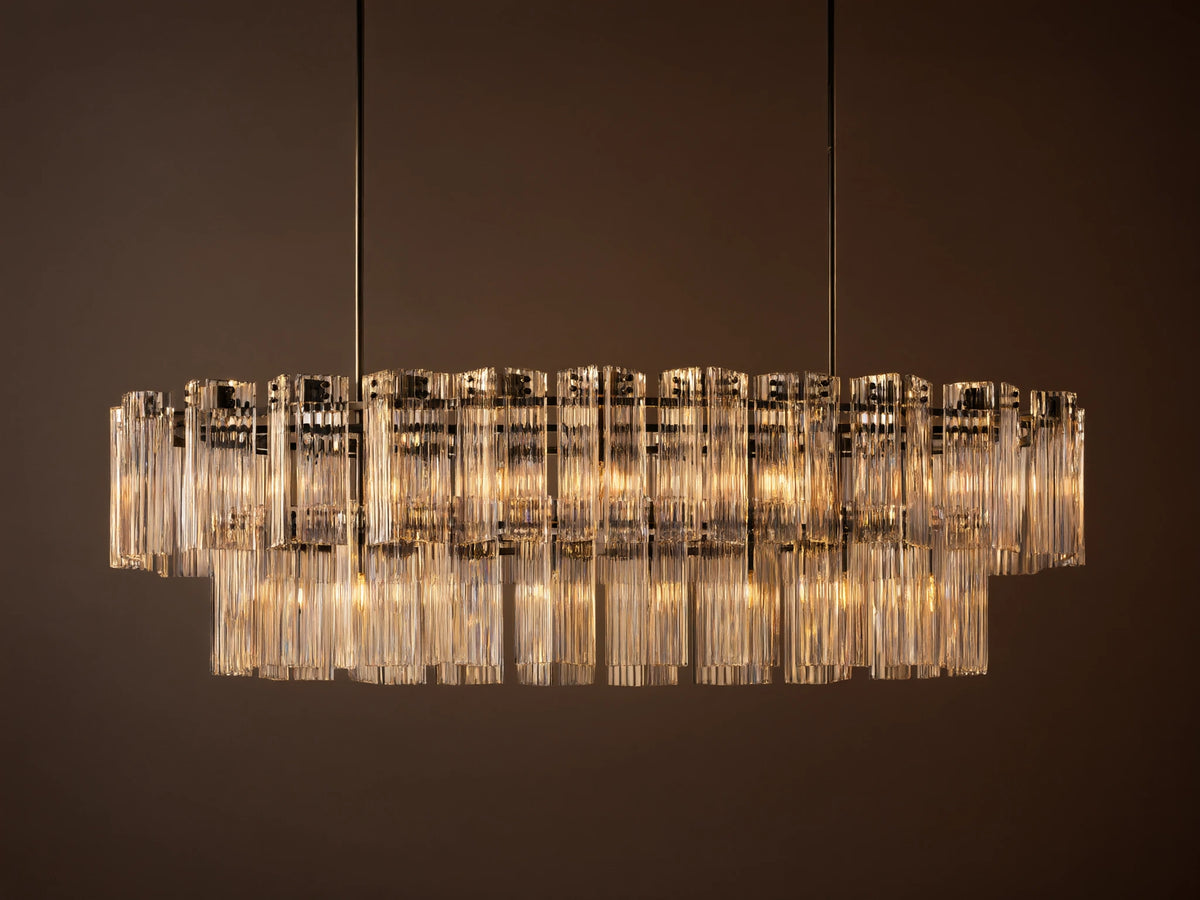 Illuminated Delsie Oval Tiered Chandelier with a dark bronze frame and multiple tiers of clear fluted glass rods.