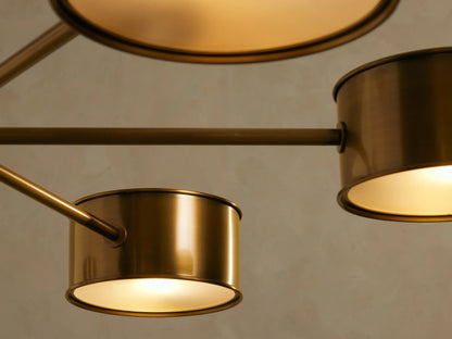 Daphne Metal Round Chandelier in antique brass, with a central rod and six arms holding cylindrical metal shades facing downwards.