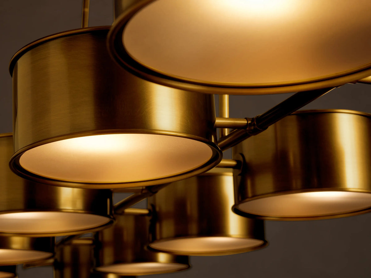 Daphne Metal Linear Chandelier, antique brass, featuring nine cylindrical shades suspended from two hanging rods.