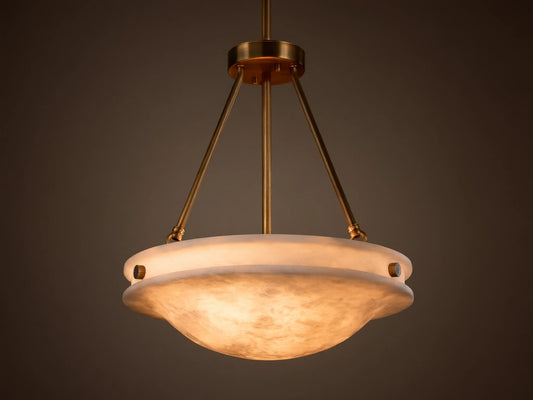 Front view of the Edith Pendant with a brass finish and a glowing, marbled alabaster stone shade.