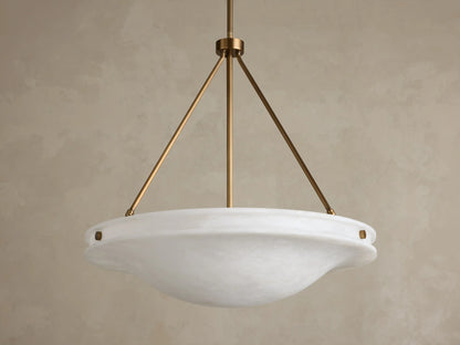 Front view of the Edith Pendant, a round white alabaster stone shade with subtle marbling, supported by three brass-finished rods.