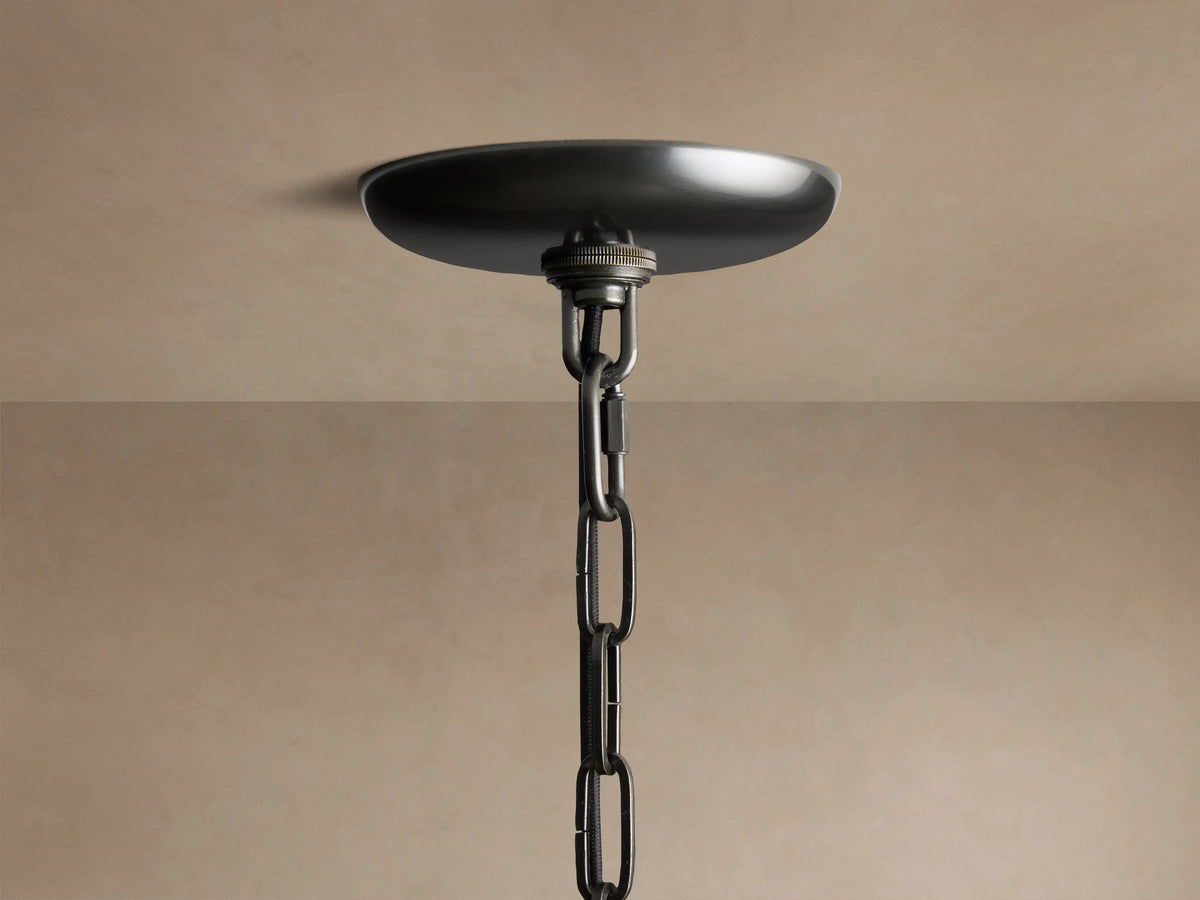 Close-up of the Ghiaccio Round Chandelier's dark metallic ceiling canopy and chain, mounted against a light ceiling.