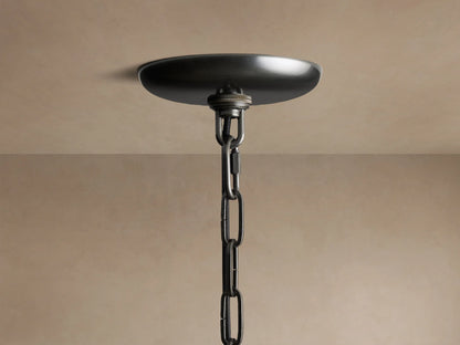 Close-up of the Ghiaccio Round Chandelier's dark metallic ceiling canopy and chain, mounted against a light ceiling.
