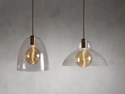 Bauer Dome Pendant's brass ceiling mount with chain and black cord. Circular base secured to white ceiling, highlighting modern design.