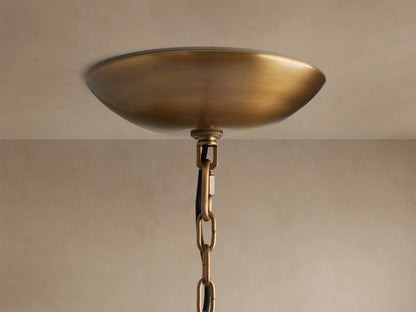 Ghiaccio Round Chandelier brass, bowl-shaped ceiling canopy with a hanging brass chain against a light-colored ceiling.