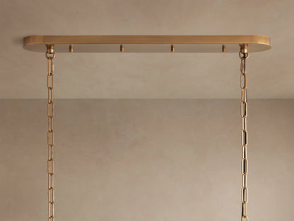 Ghiaccio Oval Chandelier close-up; clear, textured, curved glass panels reflect light, creating an icy, layered effect.