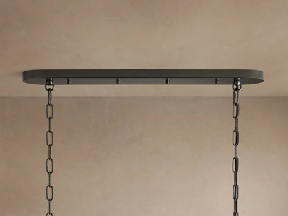 Close-up of the Ghiaccio Oval Chandelier, showcasing multiple rows of clear, curved, ice-like textured glass panels.