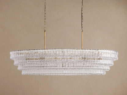 Oval Ghiaccio Chandelier with tiered, textured clear curved glass panels, glowing lights, suspended by gold rods & chains.