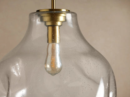 Organic 16" Pendant: Clear, organic-shaped, speckled glass shade with vintage bulb, brass accents, hanging.