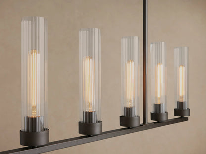 Andreas 8-light linear chandelier with a black frame and clear ribbed glass shades, suspended by chains against a light wall.