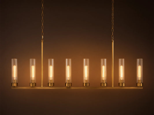 Andreas Linear Chandelier: 8-light, brass-finished, horizontal bar with clear cylindrical glass shades, exposing filament bulbs, hanging.