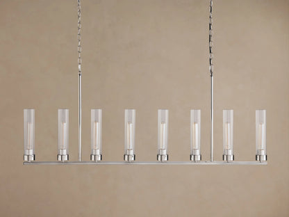 Andreas Linear Chandelier: 8-light, silver-finished linear fixture with ribbed clear glass shades & glowing filament bulbs, suspended by chains.