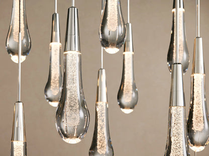 Soltaire Linear Chandelier: clear glass teardrop pendants with silver-finished caps hanging from thin wires in multiple rows.