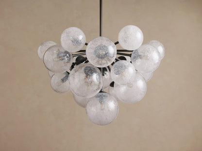 Mandoza Chandelier: Modern design with numerous textured clear glass globes on dark branching arms, against a light background.