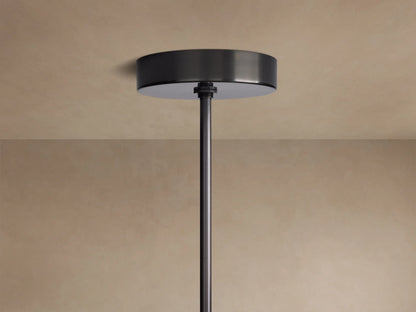 Mandoza Chandelier's dark bronze ceiling canopy and down rod mounted flush against a light beige ceiling.